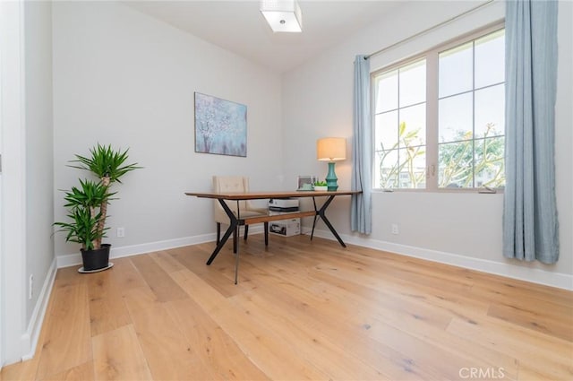 office featuring light wood-type flooring and baseboards