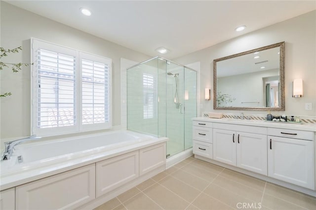 full bathroom featuring tile patterned flooring, a stall shower, vanity, and a garden tub