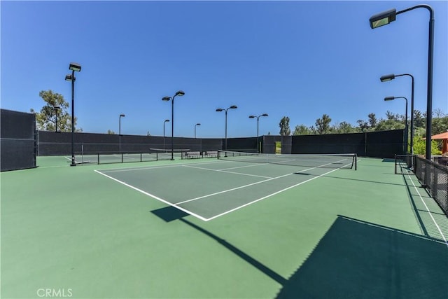 view of tennis court with fence