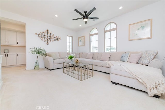 living area featuring recessed lighting, light carpet, and a ceiling fan