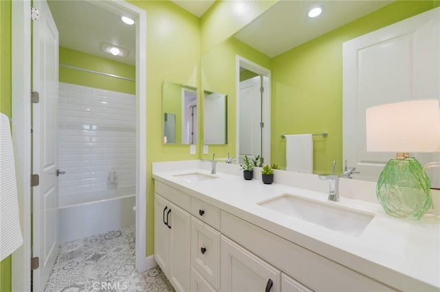 bathroom with double vanity, recessed lighting, toilet, and a sink