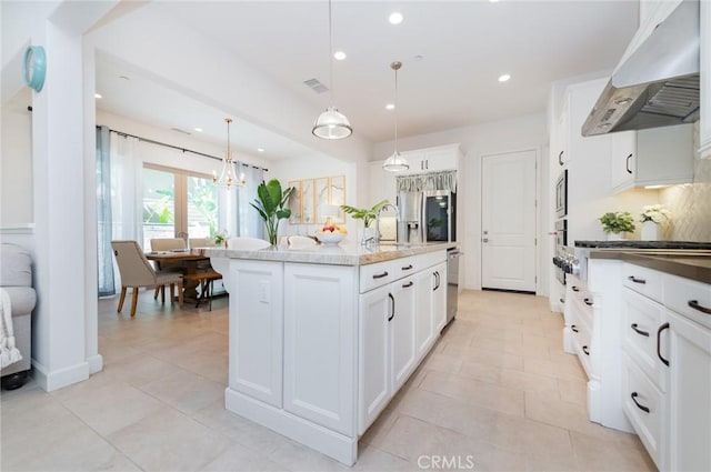 kitchen with a center island with sink, under cabinet range hood, white cabinetry, recessed lighting, and appliances with stainless steel finishes