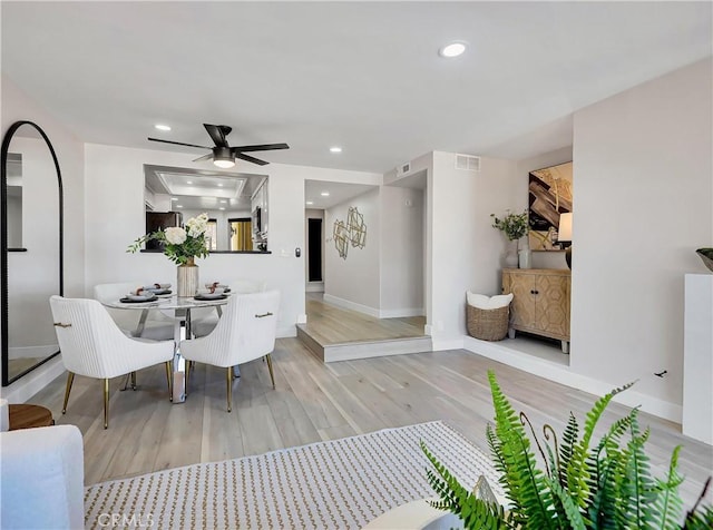 dining space with recessed lighting, baseboards, a ceiling fan, wood finished floors, and visible vents