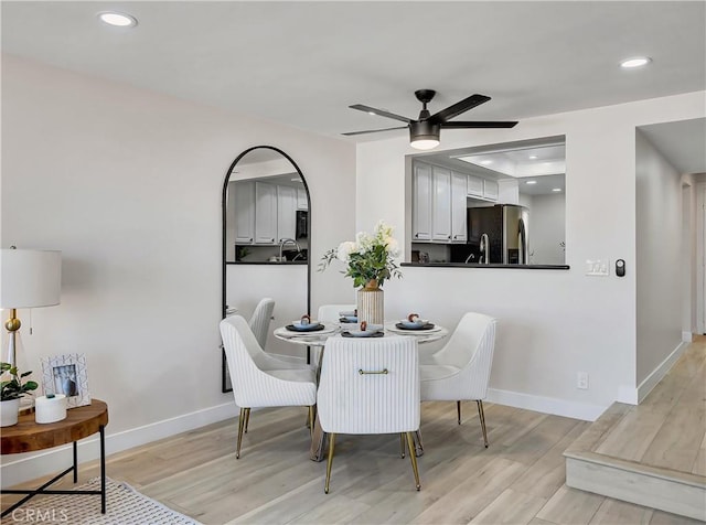 dining space featuring light wood-style flooring, recessed lighting, baseboards, and ceiling fan