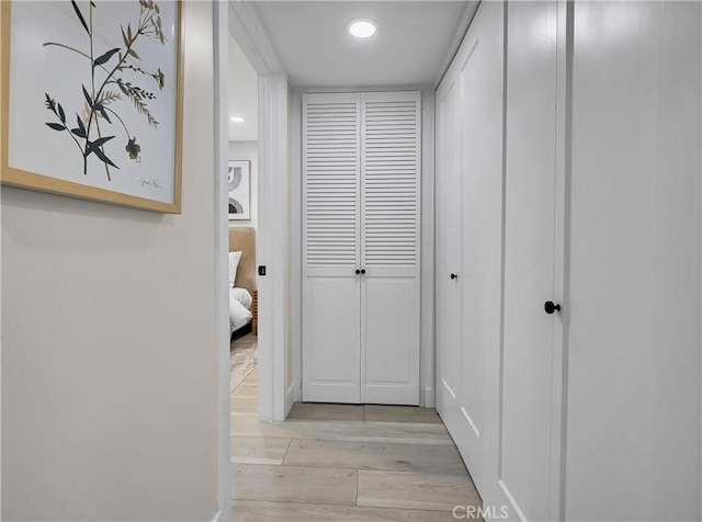 corridor featuring recessed lighting and light wood-style flooring