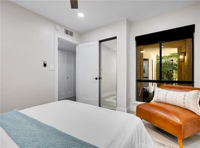 bedroom featuring visible vents, wood finished floors, recessed lighting, baseboards, and ceiling fan