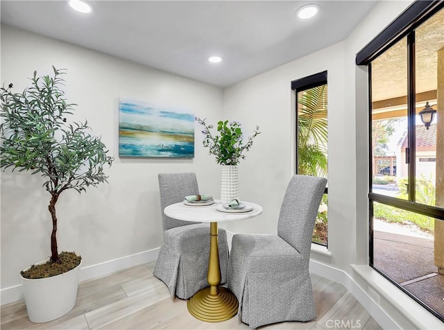 dining room featuring wood finished floors, recessed lighting, and baseboards