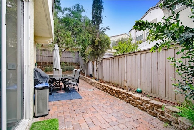 view of patio / terrace with outdoor dining space and a fenced backyard