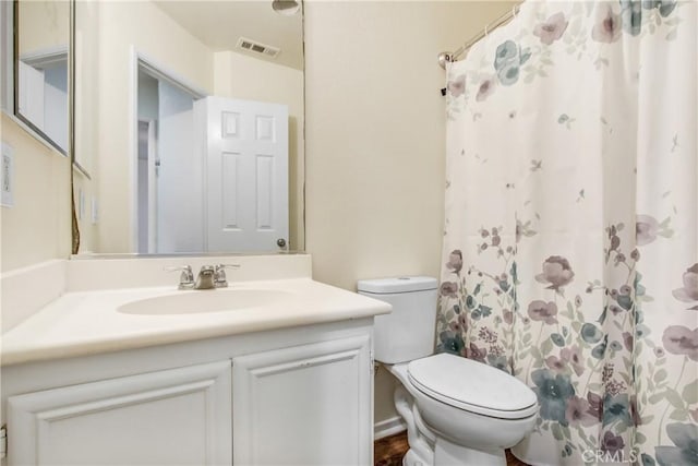 bathroom featuring visible vents, curtained shower, toilet, and vanity