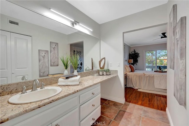 bathroom featuring vanity, baseboards, visible vents, ensuite bathroom, and tile patterned floors