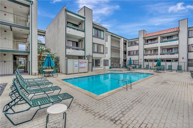 view of pool featuring a patio and fence