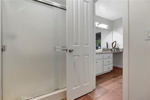 full bath featuring tile patterned flooring, a stall shower, and vanity