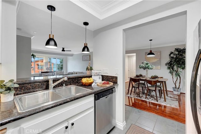 kitchen with a sink, stainless steel dishwasher, crown molding, and white cabinetry