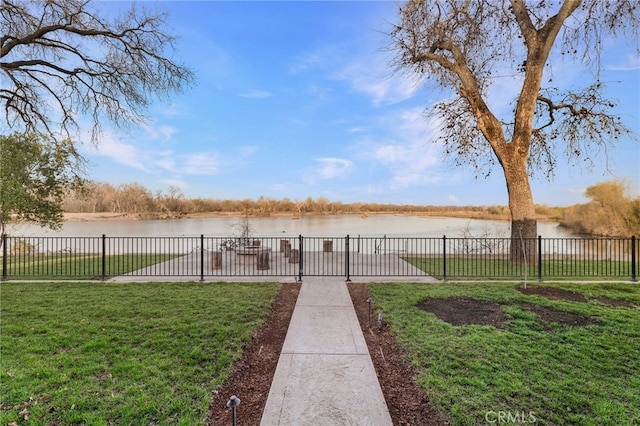 view of yard featuring fence and a water view