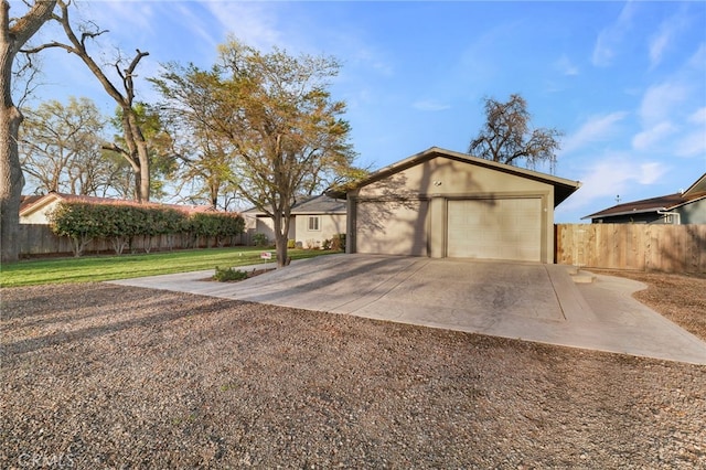 mid-century modern home with a garage, concrete driveway, a front yard, and fence