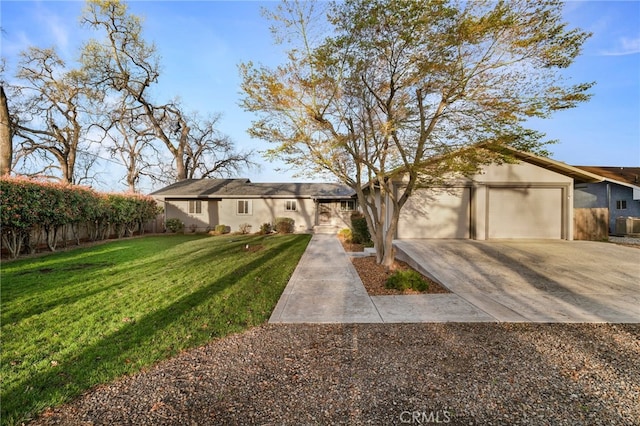 mid-century home featuring a front yard, a garage, driveway, and stucco siding