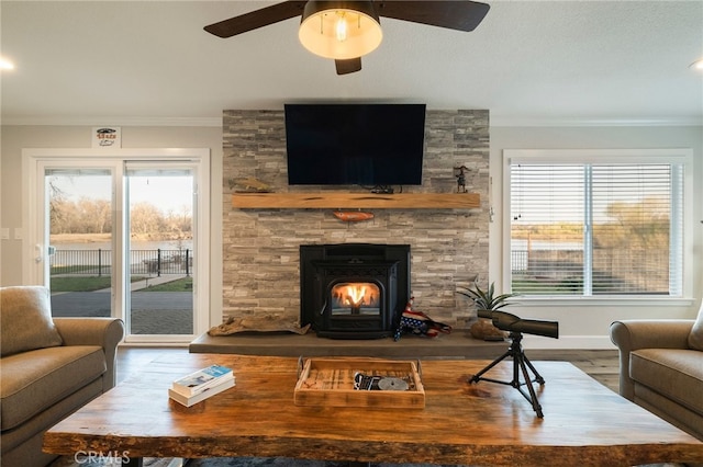 living room featuring a ceiling fan, wood finished floors, baseboards, and ornamental molding