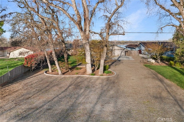 view of front of property featuring fence and driveway