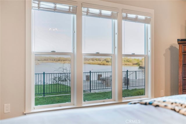 unfurnished bedroom featuring a water view