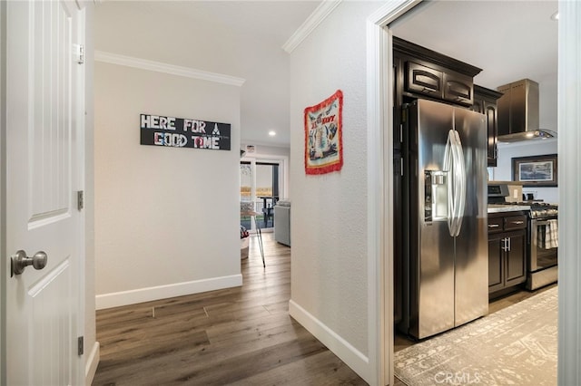 corridor featuring light wood finished floors, crown molding, baseboards, and a textured wall