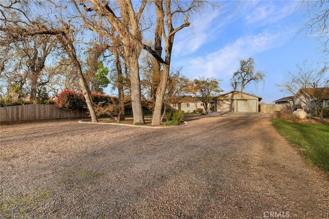 view of front of house featuring driveway and fence