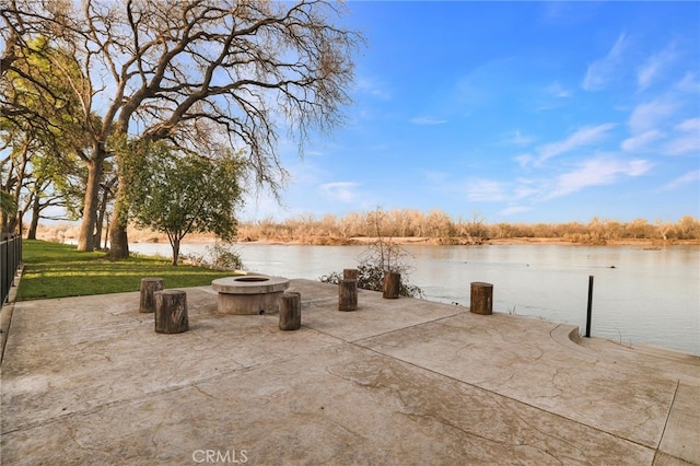 view of patio featuring a water view and a fire pit