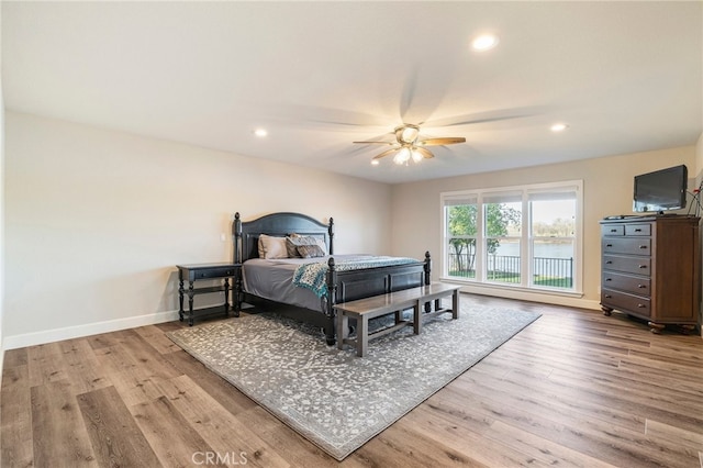 bedroom with recessed lighting, baseboards, and wood finished floors