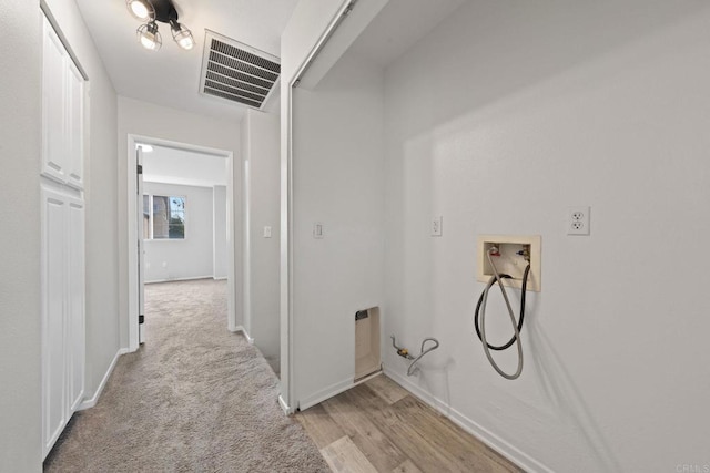 washroom with laundry area, hookup for a washing machine, baseboards, and visible vents