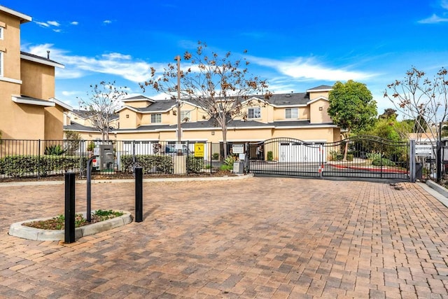 exterior space featuring a residential view, a gated entry, and a gate