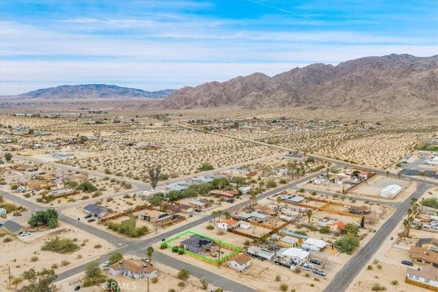 birds eye view of property with a mountain view and a desert view