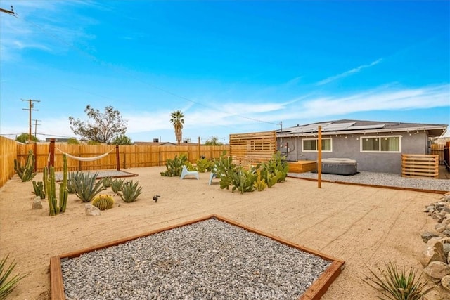 view of yard with a patio, a fenced backyard, and a hot tub