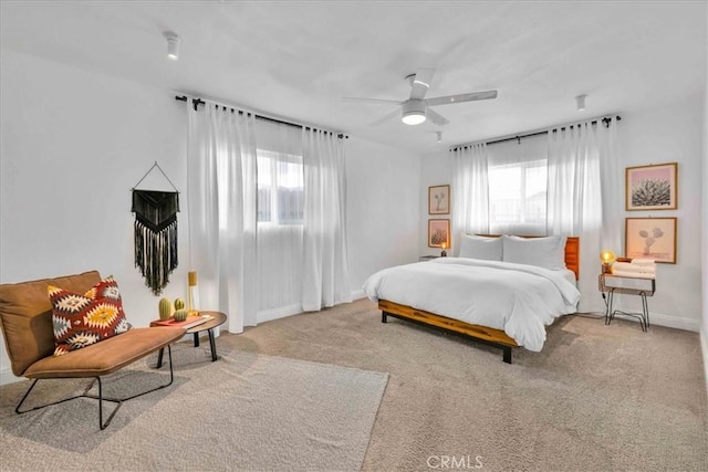 carpeted bedroom with baseboards and ceiling fan