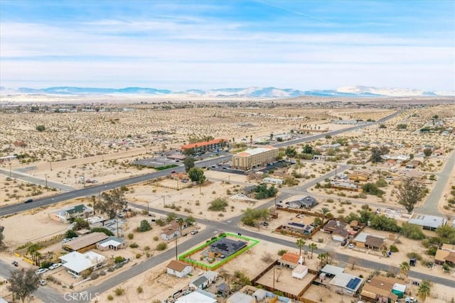 birds eye view of property with a mountain view and a desert view