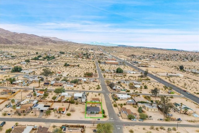 birds eye view of property with a mountain view and a desert view