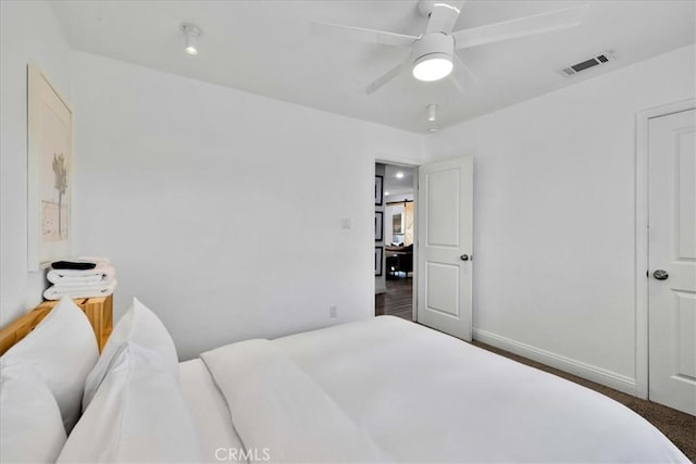 bedroom with baseboards, visible vents, and ceiling fan