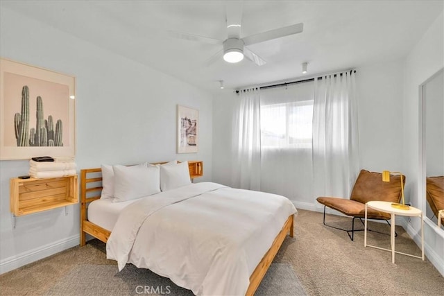 carpeted bedroom featuring baseboards and ceiling fan