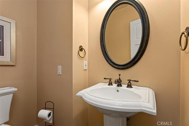 bathroom with toilet and a sink