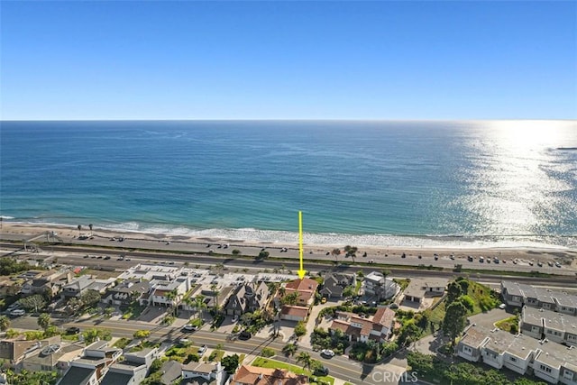 drone / aerial view with a residential view, a beach view, and a water view