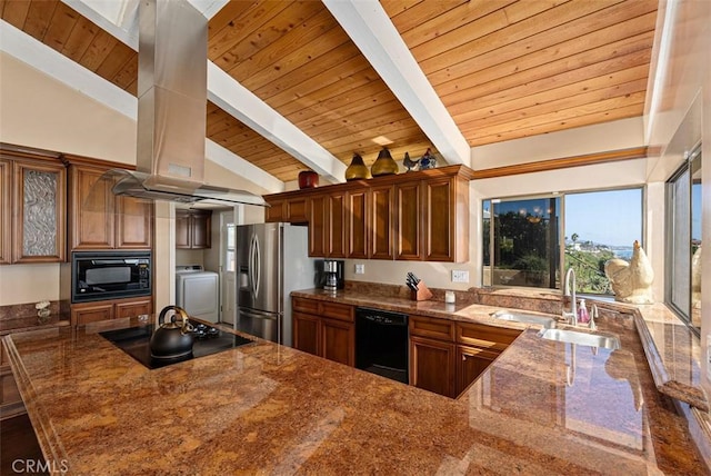 kitchen featuring black appliances, a sink, dark stone countertops, washer / clothes dryer, and exhaust hood