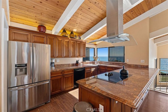 kitchen featuring brown cabinets, black appliances, a sink, a peninsula, and dark wood-style flooring