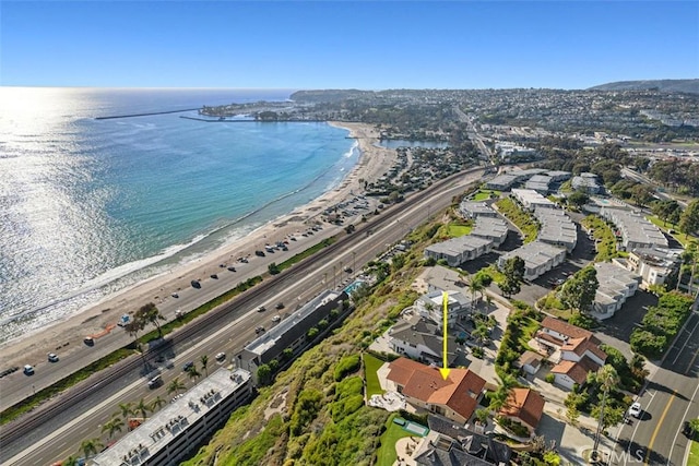 drone / aerial view featuring a beach view and a water view