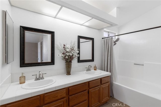 bathroom featuring a sink, shower / tub combo with curtain, and double vanity