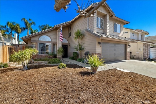 view of front of home featuring concrete driveway, an attached garage, and fence