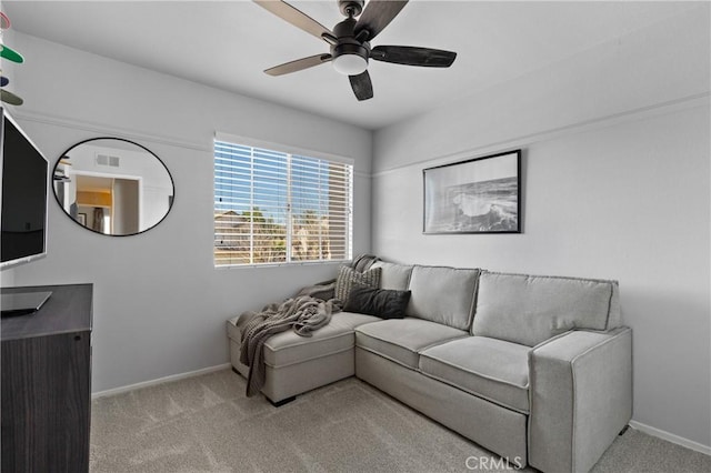 carpeted living room with visible vents, baseboards, and ceiling fan