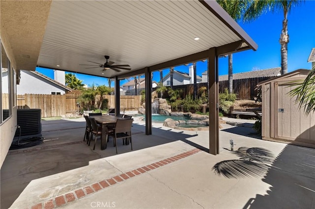 view of patio / terrace featuring outdoor dining area, central air condition unit, a fenced backyard, and a shed