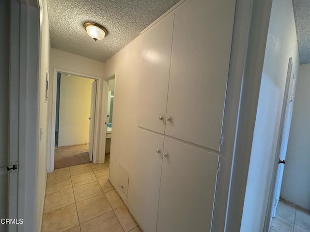 3700 Dean Dr Unit 3405, Ventura, CA 93003 - hall featuring light tile patterned floors and a textured ceiling