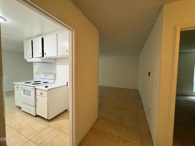 3700 Dean Dr Unit 3405, Ventura, CA 93003 - interior space featuring light tile patterned floors, electric range, white cabinets, and light countertops