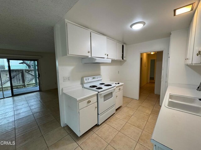 3700 Dean Dr Unit 3405, Ventura, CA 93003 - kitchen featuring under cabinet range hood, light countertops, electric range, white cabinetry, and a sink