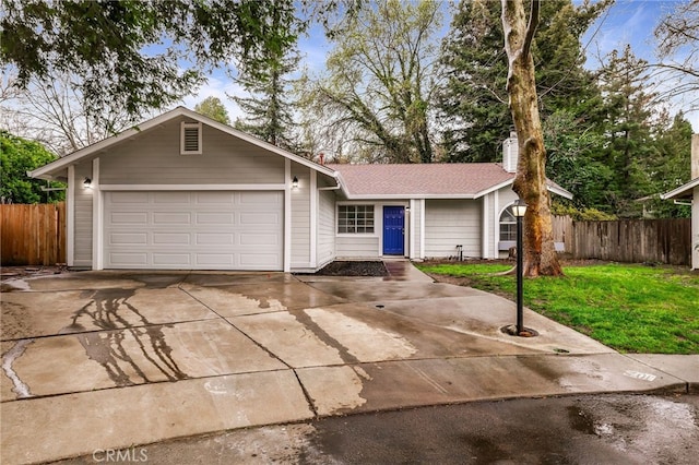 ranch-style house with driveway, an attached garage, a front yard, and fence