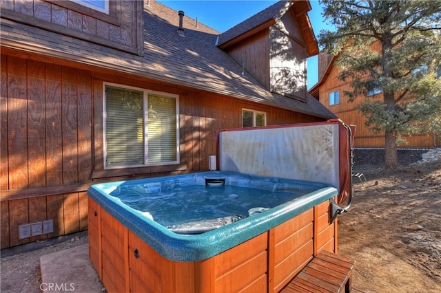 view of patio with visible vents and a hot tub